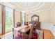 Formal dining room featuring an elegant chandelier, tray ceiling, and wainscoting at 1317 Woodgate Manor Ct, Raleigh, NC 27614