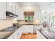 Updated kitchen with stainless steel appliances, granite countertops, and ample cabinet space at 1317 Woodgate Manor Ct, Raleigh, NC 27614