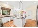 Well-lit open kitchen showcases a center island and seamless connectivity to the breakfast nook at 1317 Woodgate Manor Ct, Raleigh, NC 27614