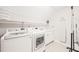 Bright laundry room with modern washer and dryer, storage, and utility sink at 1317 Woodgate Manor Ct, Raleigh, NC 27614
