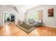 Bright living room with hardwood floors, vaulted ceilings, and views into an office space at 1317 Woodgate Manor Ct, Raleigh, NC 27614