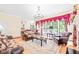 Elegant living room boasting hardwood floors, large windows, luxurious seating, and ornate details at 1317 Woodgate Manor Ct, Raleigh, NC 27614