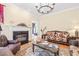 Charming living room with a fireplace, hardwood floors, and plush seating arrangements at 1317 Woodgate Manor Ct, Raleigh, NC 27614