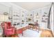 Elegant home office with custom built-in bookshelves, hardwood floors, and an area rug at 1317 Woodgate Manor Ct, Raleigh, NC 27614