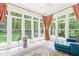 Bright sun room with lots of windows, neutral tile flooring, and comfortable chaise lounge at 1317 Woodgate Manor Ct, Raleigh, NC 27614