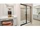 Bathroom featuring glass shower and makeup vanity, with view into walk-in closet at 137 Azalea View Way, Holly Springs, NC 27540