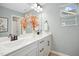 Bathroom featuring double sinks, modern fixtures, vanity with drawers, and a large decorative mirror at 137 Azalea View Way, Holly Springs, NC 27540