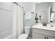 Bathroom features a shower/tub combo with white tile surround, matching vanity and stylish fixtures at 137 Azalea View Way, Holly Springs, NC 27540