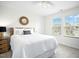 Bright bedroom featuring a comfy bed, wood bedside table, modern ceiling fan, and great natural light at 137 Azalea View Way, Holly Springs, NC 27540