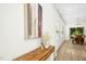 Hallway with console table and art leading to dining area and featuring hardwood floors and natural light at 137 Azalea View Way, Holly Springs, NC 27540
