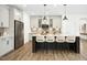 Modern kitchen with stainless steel appliances, a spacious island with seating, and stylish pendant lighting at 137 Azalea View Way, Holly Springs, NC 27540