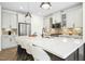 Bright kitchen features stainless steel appliances, a large center island, and elegant pendant lighting at 137 Azalea View Way, Holly Springs, NC 27540