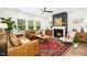 Bright living room with natural light, hardwood floors, fireplace and neutral tones creating a comfortable ambiance at 137 Azalea View Way, Holly Springs, NC 27540