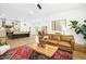 Open-concept living area with barstool seating, hardwood floors and a dining area beyond the comfy couches at 137 Azalea View Way, Holly Springs, NC 27540