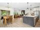 Bright, open living space featuring a kitchen island, dining area, and comfortable living room with a fireplace at 137 Azalea View Way, Holly Springs, NC 27540