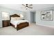 Calm and spacious main bedroom with ceiling fan, carpet floors, side tables and decorative wall art at 137 Azalea View Way, Holly Springs, NC 27540