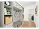 Well-organized mudroom with built-in storage, seating, and hooks for coats and bags at 137 Azalea View Way, Holly Springs, NC 27540