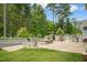 Spacious outdoor patio with a fire pit, grill, and seating offers a serene backyard retreat at 137 Azalea View Way, Holly Springs, NC 27540