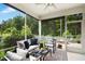 Inviting screened porch offers comfortable seating and a relaxing outdoor living space overlooking a wooded area at 137 Azalea View Way, Holly Springs, NC 27540