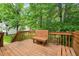 Wooden back deck with bench seating overlooking the yard and trees at 1409 Beckworth Ct, Garner, NC 27529
