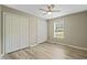 Bedroom showcasing light wood floors, multiple closets, and a ceiling fan at 1409 Beckworth Ct, Garner, NC 27529