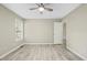 Bedroom with neutral walls, wood-look floors, ceiling fan, and a large window at 1409 Beckworth Ct, Garner, NC 27529