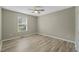 Bedroom with neutral paint, window and light wood floors at 1409 Beckworth Ct, Garner, NC 27529