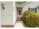 A welcoming front entryway adorned with vibrant greenery and a charming wreath at 1409 Beckworth Ct, Garner, NC 27529