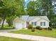 Single-story home featuring a well-manicured lawn, an attached garage, and a sidewalk at 1409 Beckworth Ct, Garner, NC 27529