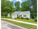 Single-story home with an attached garage, attractive landscaping, and a sidewalk at 1409 Beckworth Ct, Garner, NC 27529