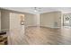 Open-concept living room with hardwood flooring and neutral paint, leading to the kitchen and the front door at 1409 Beckworth Ct, Garner, NC 27529