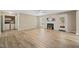 Open-concept living room with a fireplace, ceiling fan, and luxury vinyl plank flooring at 1409 Beckworth Ct, Garner, NC 27529