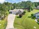 Expansive aerial view of a tan home featuring an attached garage and large, well-maintained lawn at 142 Crestline Dr, Selma, NC 27576