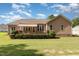 Charming single story home with a manicured lawn and wood deck at 142 Crestline Dr, Selma, NC 27576