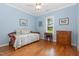 Bedroom with a hardwood floor, light blue paint and lots of natural light at 142 Crestline Dr, Selma, NC 27576