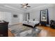 Primary bedroom features a tray ceiling, hardwoods, neutral paint and large windows at 142 Crestline Dr, Selma, NC 27576