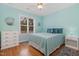 Bedroom with a hardwood floor, mint paint and lots of natural light at 142 Crestline Dr, Selma, NC 27576