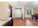 Bright foyer featuring hardwood floors leading to various rooms with natural light and a white front door at 142 Crestline Dr, Selma, NC 27576
