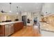 Bright kitchen with wood cabinets, stainless steel appliances, granite counters and a hardwood floor at 142 Crestline Dr, Selma, NC 27576