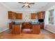 Bright office space featuring built-in cabinets, dual desks, and a ceiling fan at 142 Crestline Dr, Selma, NC 27576