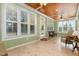 Well-lit sunroom with many windows and tiled flooring at 142 Crestline Dr, Selma, NC 27576