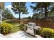 Spacious backyard with a stainless steel grill, lush lawn, and mature trees at 1508 Heritage Reserve Ct, Wake Forest, NC 27587