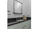 Bathroom vanity featuring a black countertop, oval sink, and a framed mirror at 1508 Heritage Reserve Ct, Wake Forest, NC 27587