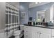 Stylish bathroom with a gray and white striped shower curtain and a vanity with plenty of storage at 1508 Heritage Reserve Ct, Wake Forest, NC 27587