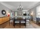 Bright dining room with a long table and views into the comfortable living room with fireplace at 1508 Heritage Reserve Ct, Wake Forest, NC 27587