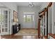 Welcoming foyer with hardwood floors, elegant lighting, and staircase at 1508 Heritage Reserve Ct, Wake Forest, NC 27587