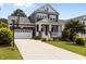 Charming two-story home with a front porch, attached garage, and well-manicured lawn at 1508 Heritage Reserve Ct, Wake Forest, NC 27587