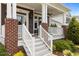 Inviting front porch with brick accents and steps leading to the entrance at 1508 Heritage Reserve Ct, Wake Forest, NC 27587