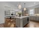 Open-concept kitchen with a large island, modern appliances, and seamless flow to the living area at 1508 Heritage Reserve Ct, Wake Forest, NC 27587