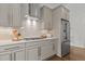 Modern kitchen features stainless steel appliances, gray cabinetry, white subway tile backsplash, and marble countertops at 1508 Heritage Reserve Ct, Wake Forest, NC 27587